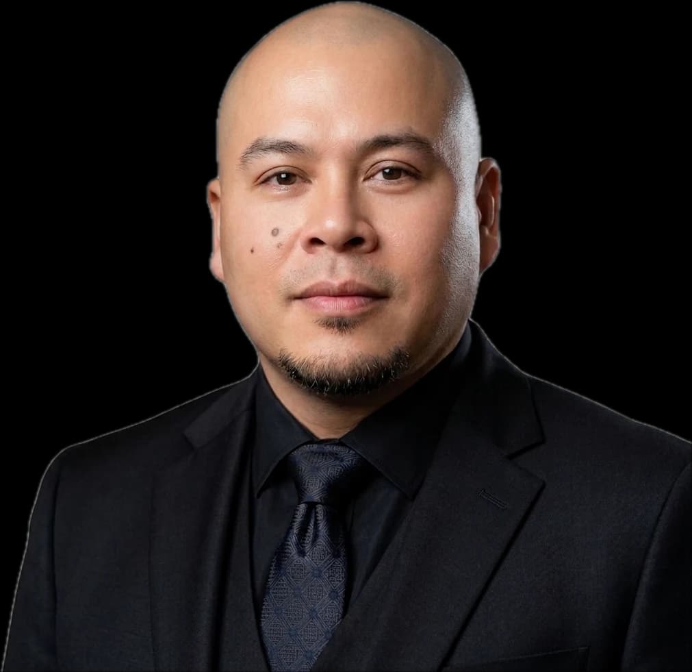 Rex Villamor in a black suit and tie